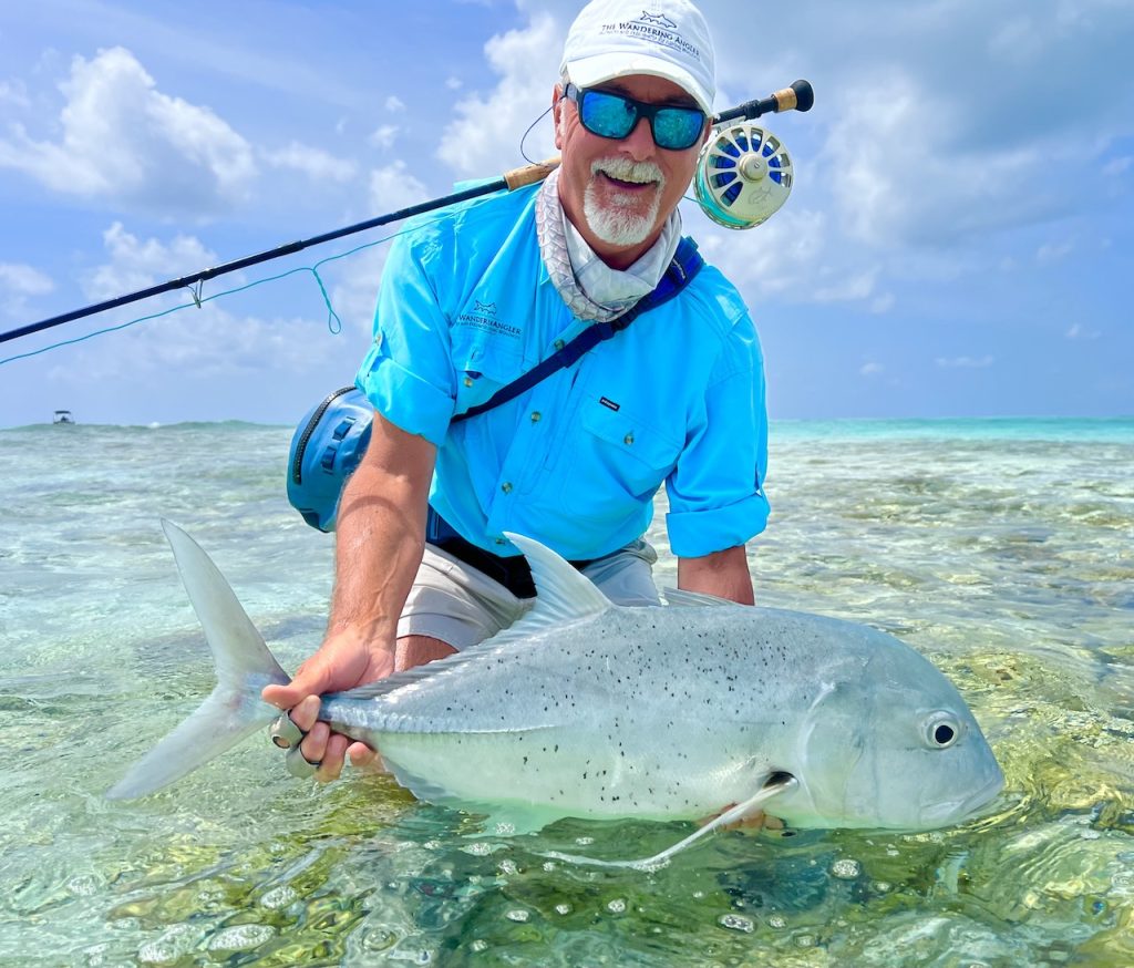 Tourists enjoying an affordable traditional line fishing trip with local Maldivian fishermen on a wooden boat.