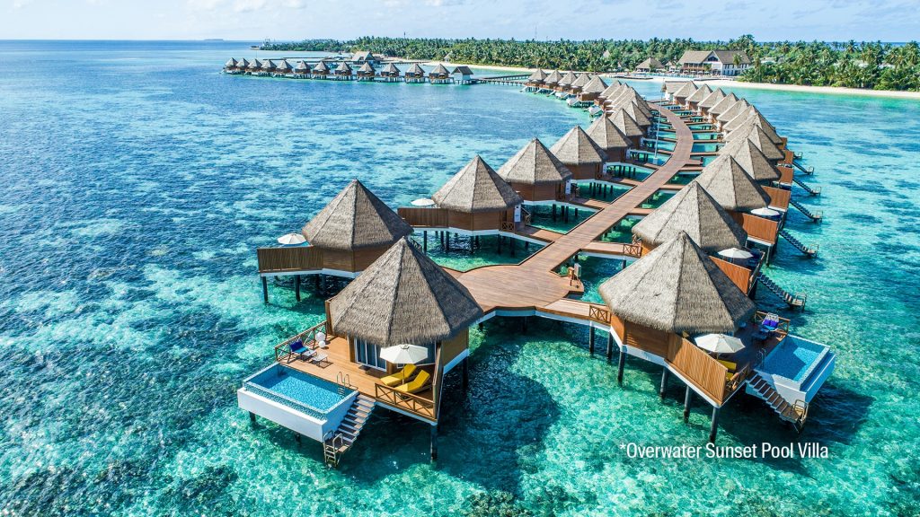 Aerial view of luxury overwater villas and turquoise lagoon in Gaafu Alifu Atoll, Maldives.