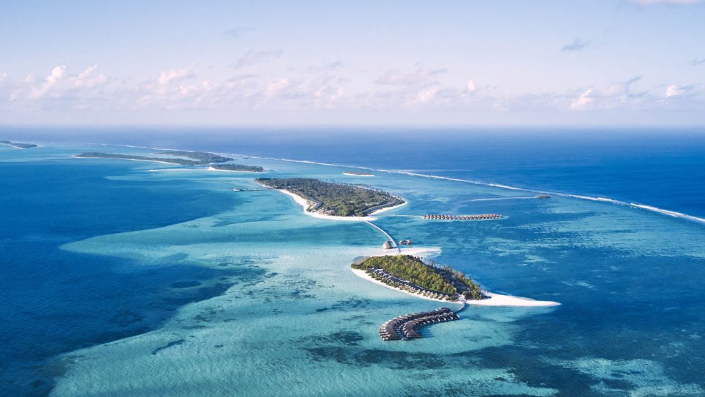 Aerial view of luxury overwater bungalows and turquoise lagoons in Lhaviyani Atoll, Maldives.