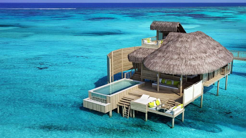 Luxury overwater villas and turquoise lagoon at Six Senses Laamu, Maldives luxury travel guide.