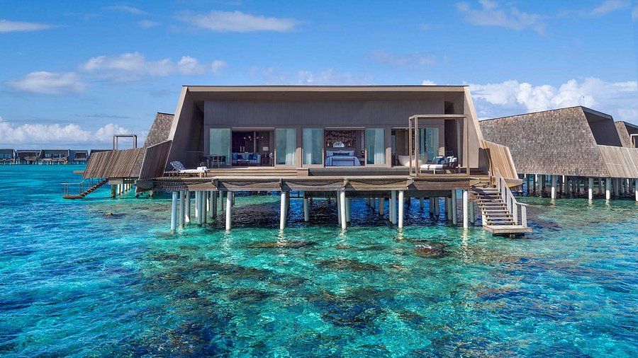 Modern luxury overwater villa at St. Regis Maldives Vommuli Resort with crystal clear ocean views.
