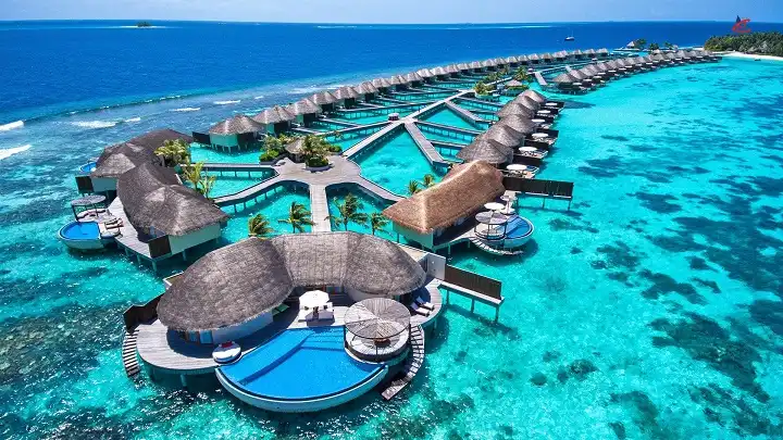 Aerial view of luxury overwater villas in Vaavu Atoll, Maldives, showcasing crystal clear turquoise water and premium resort stay options.