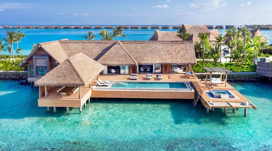 Luxury overwater villa with private infinity pool at Waldorf Astoria Maldives Ithaafushi resort.