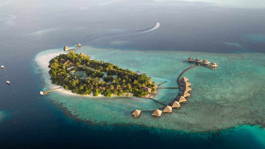 Overwater bungalows at Adaaran Club Rannalhi Maldives, an affordable honeymoon resort for couples seeking privacy and value.