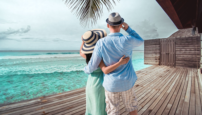 A romantic overwater villa at an affordable honeymoon resort in Maldives with turquoise ocean view.