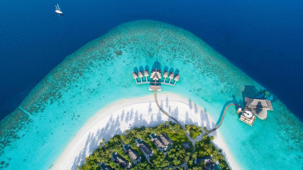 Aerial view of Anantara Kihavah Maldives luxury overwater villas and turquoise lagoon in Baa Atoll UNESCO Biosphere Reserve.