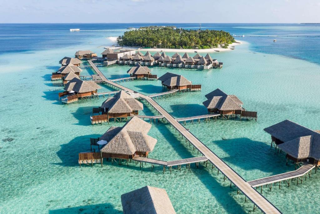 Aerial view of luxury water villas at Conrad Maldives Rangali Island, a top honeymoon destination in Maldives with crystal clear turquoise water.