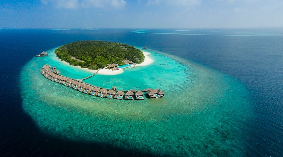 Aerial view of Dusit Thani Maldives luxury resort in Baa Atoll featuring overwater villas and turquoise lagoon.