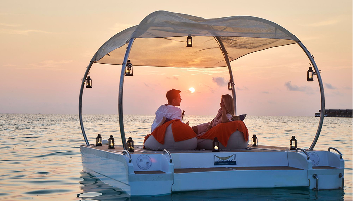 A luxury overwater villa in the Maldives at sunset, perfect for a private and romantic honeymoon escape for couples.