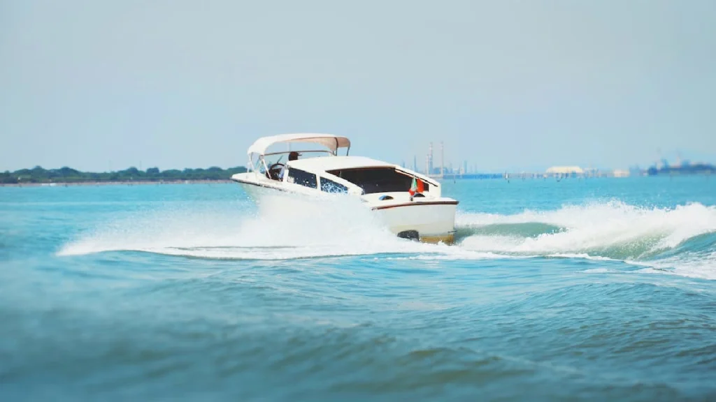 A luxury white speedboat cruising through the turquoise waters of Maldives, representing island transfer options.