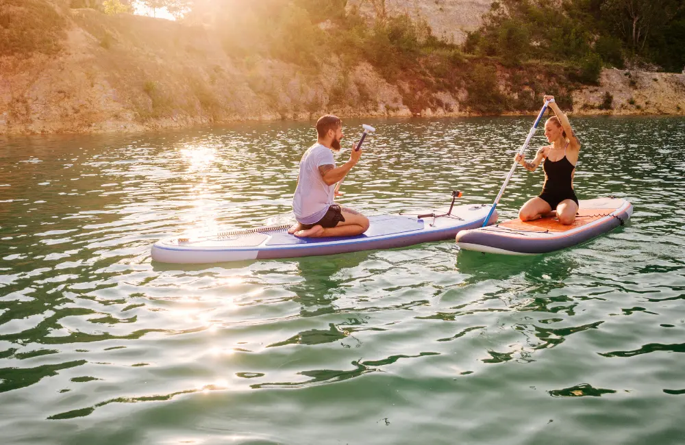 A traveler kayaking in the turquoise lagoon of Noonu Atoll, Maldives, showcasing water sports and luxury activities.