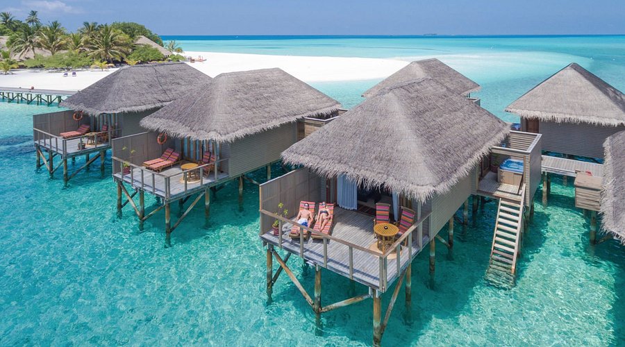 Luxury overwater villas with private sundecks at Meeru Island Resort and Spa, a top-rated honeymoon destination in the Maldives.