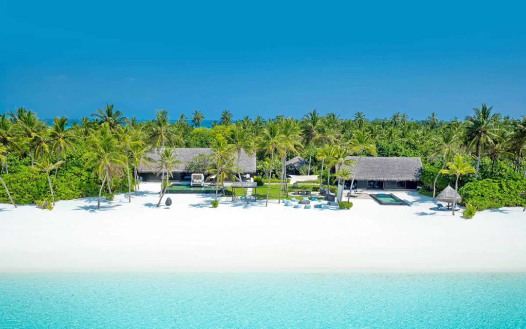An aerial view of an ultra-luxury overwater villa at One & Only Reethi Rah resort in the Maldives, perfect for a romantic honeymoon.