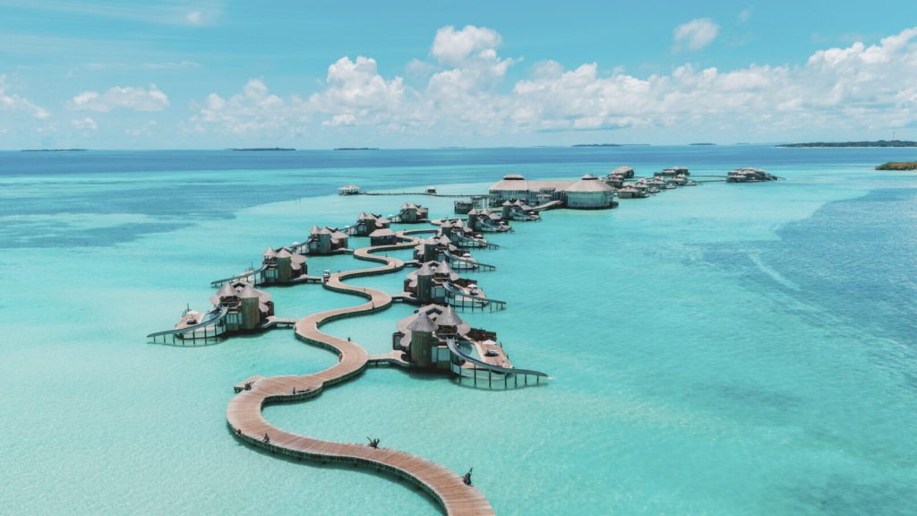 Luxury overwater honeymoon villa with private water slide and pool in Soneva Jani Maldives resort.
