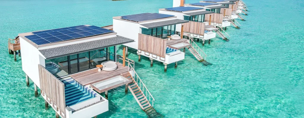 Modern eco-friendly overwater villas with solar panels and private pools at Patina Maldives Fari Islands.