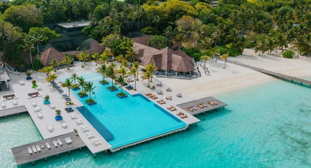 Aerial view of Villa Nautica Maldives infinity pool and beach villas, one of the best family-friendly resorts in the Maldives.