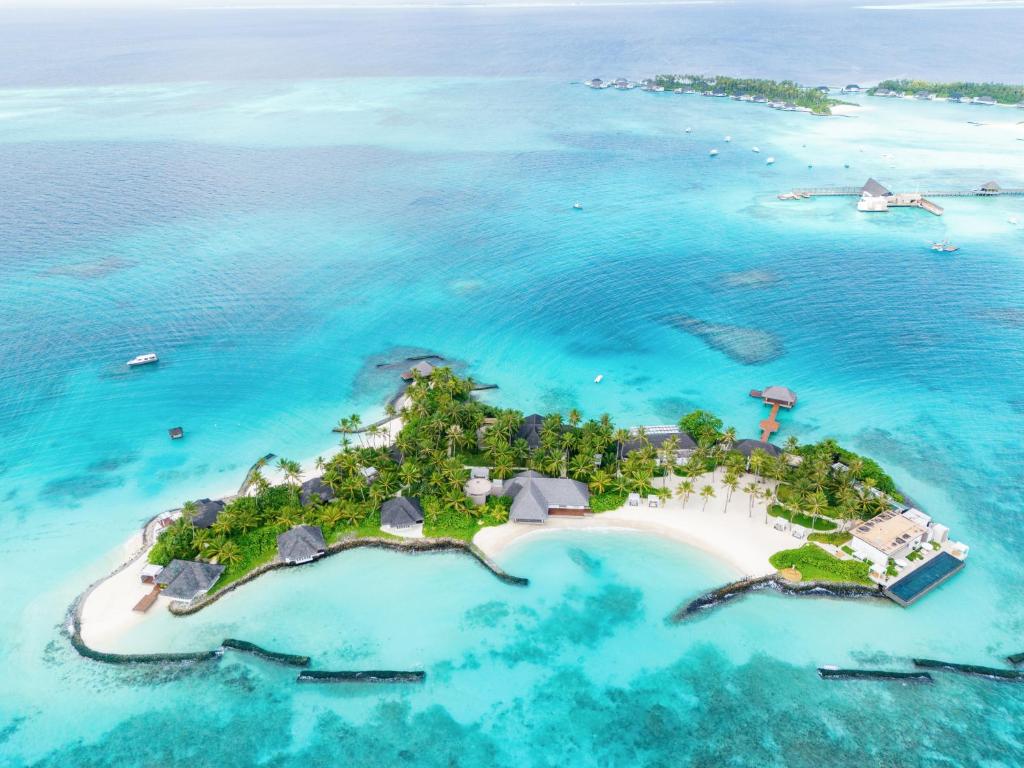 Aerial view of Cheval Blanc Randheli luxury resort in Noonu Atoll, Maldives, featuring private villas and turquoise lagoons.