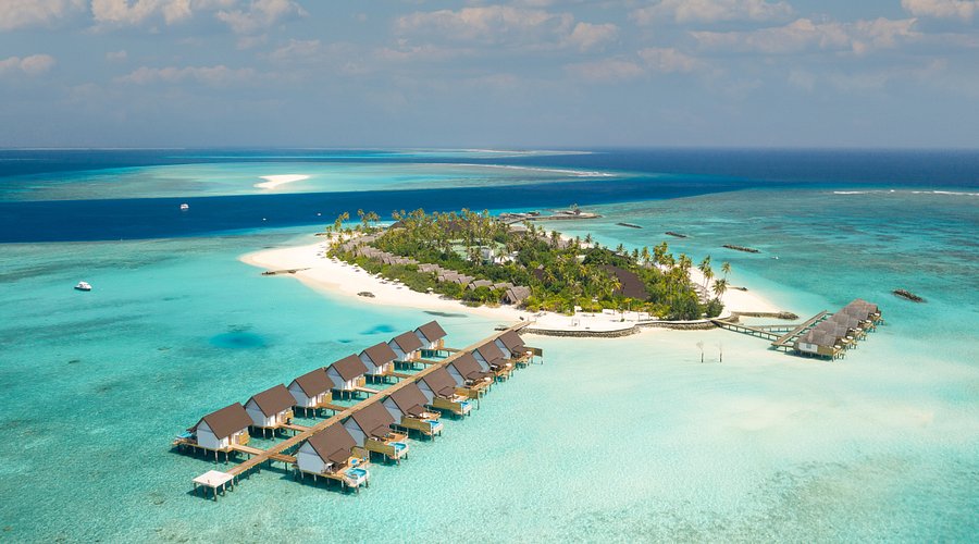 Aerial shot of Fushifaru Maldives resort featuring luxury overwater villas, white sandy beaches, and turquoise lagoons in Lhaviyani Atoll.