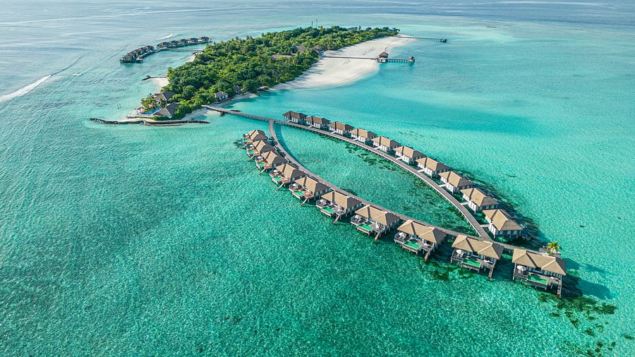 Aerial view of Noku Maldives luxury water villas and turquoise lagoon in Noonu Atoll.