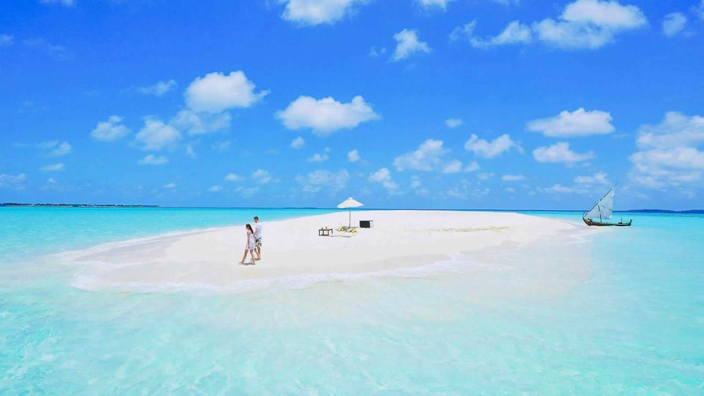 A secluded white sandbank surrounded by turquoise crystal-clear water in Meemu Atoll, Maldives—ideal for an untouched island escape.