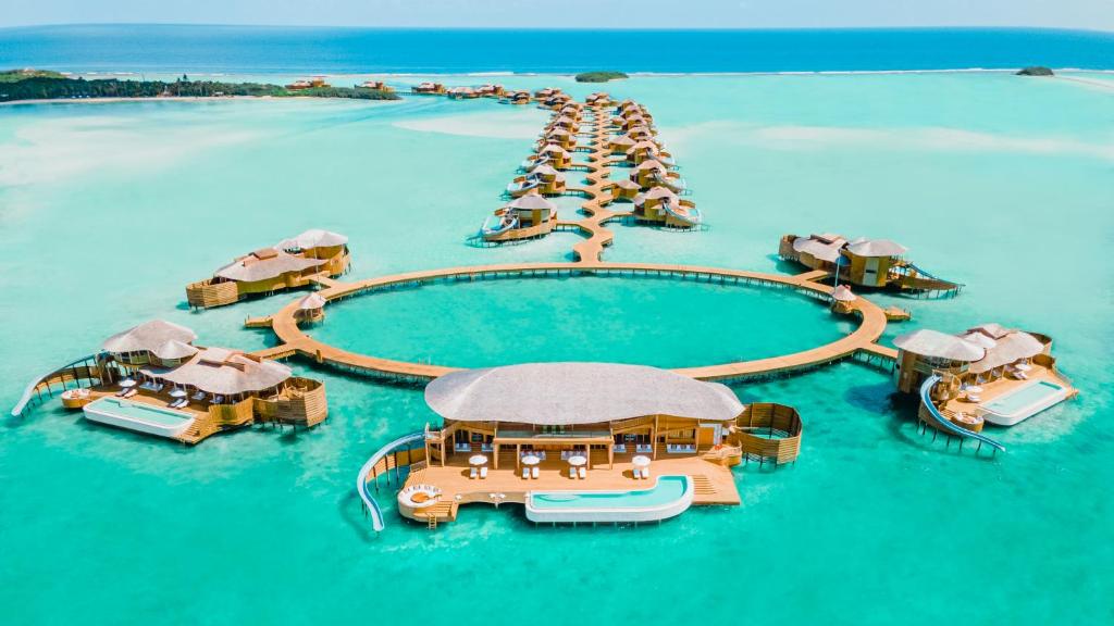 Luxury overwater villas with private slides and turquoise lagoon at Soneva Jani resort in Noonu Atoll, Maldives.