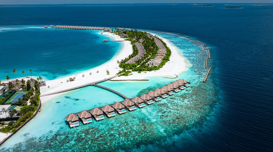 Aerial view of Sun Siyam Iru Veli luxury water villas and white sandy beach in Dhaalu Atoll, Maldives.