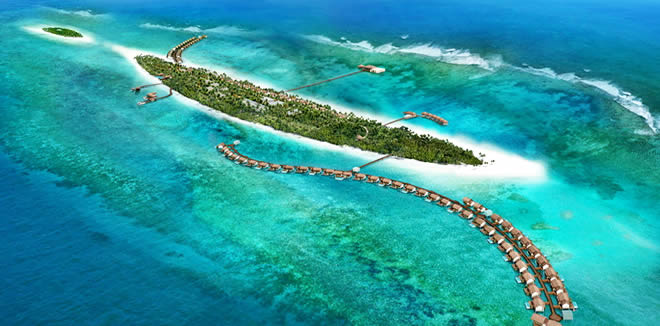 Aerial view of a luxury island resort in Gaafu Alifu Atoll, Maldives, showing overwater bungalows, turquoise lagoons, and vibrant coral reefs for diving.