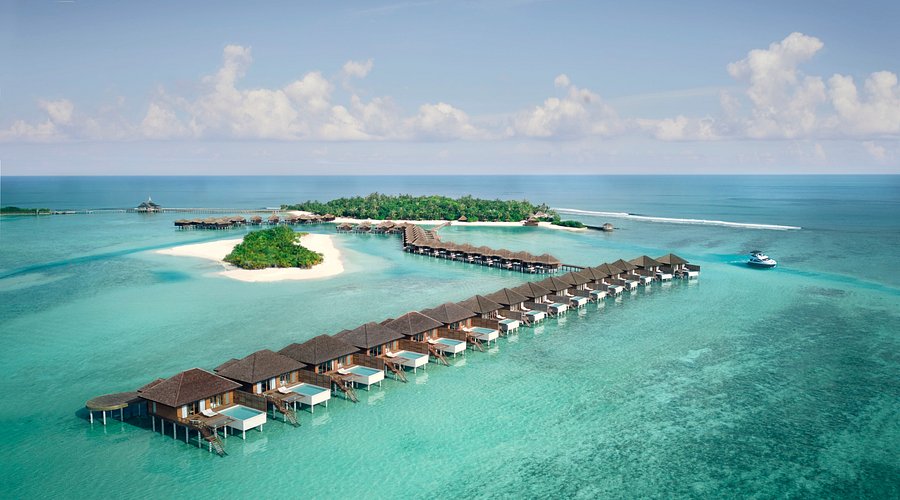 Aerial view of Anantara Veli Maldives Resort overwater bungalows and turquoise lagoon near Maafushi.