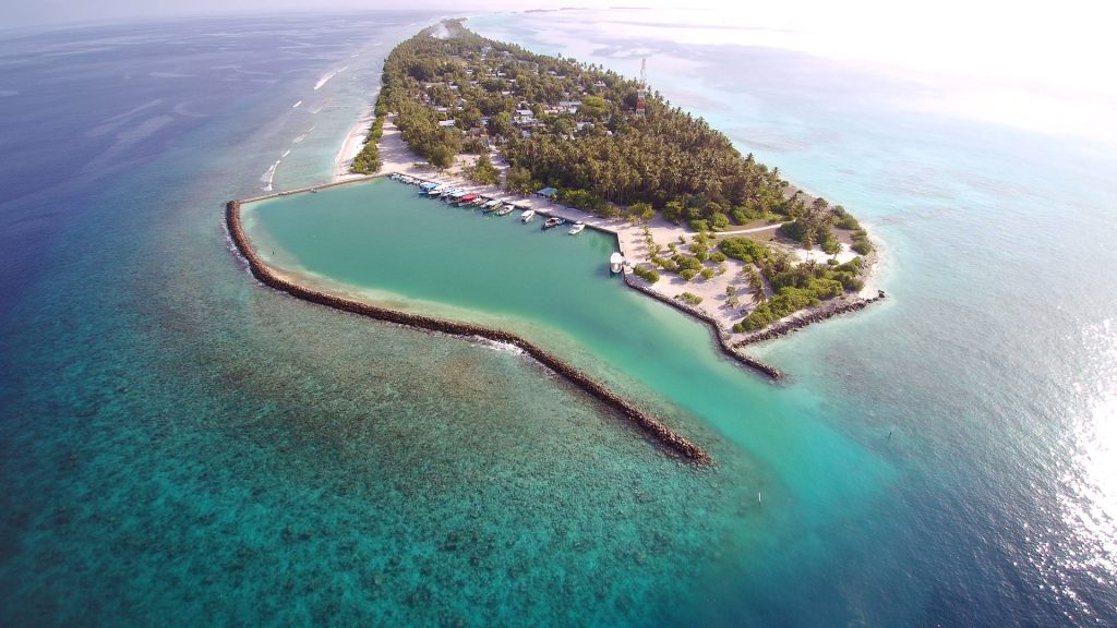 Aerial view of Dhigurah island with white sand beaches and turquoise water, a top budget-friendly local island in Maldives for 2026.