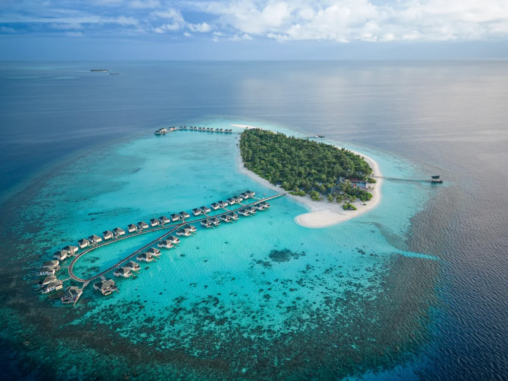 Aerial view of NH Collection Maldives Havodda Resort in Gaafu Dhaalu Atoll featuring overwater villas and turquoise lagoon.