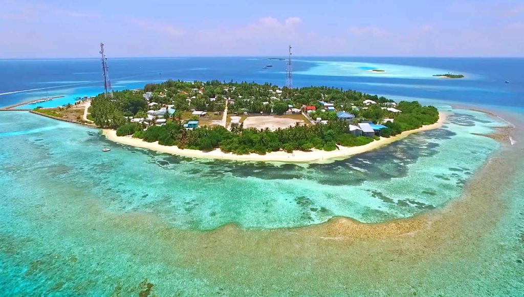 Aerial view of Rasdhoo local island in Maldives featuring turquoise lagoons and white sandy beaches for budget travelers.