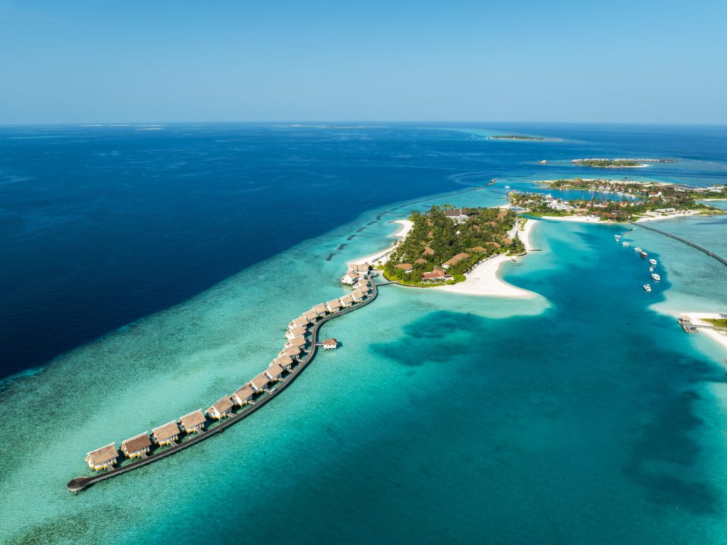 Aerial view of SAii Lagoon Maldives Curio Collection by Hilton featuring overwater villas and turquoise lagoons near Maafushi.