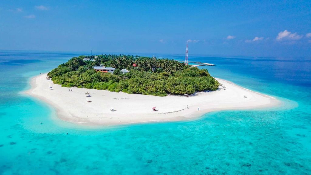 Aerial view of Ukulhas local island in the Maldives featuring white sandy beaches and turquoise water for budget travelers.