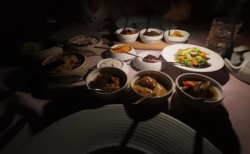 Every morning, guests find breakfast waiting under soft island light at the Ocean Restaurant. Dinner comes later as a trio of courses, each part planned ahead. One full day before eating, visitors pick what they want to have on their plate. This gives cooks time to gather just-right ingredients from nearby spots. Because meals are chosen early, flavors come through sharper, fresher. What lands on the table feels made, not rushed.

Dinner: A Three-Course Experience

Midway through the meal, Milaidhoo's kitchen revealed a quiet mastery few island resorts achieve. Instead of grand gestures, tiny moments stood out - like how the garlic shrimp rested in oil so rich it turned each crumb of bread into something necessary. Three prawns arrived, yet none felt wasted, their sauce too valuable to leave behind. Across the table, the soup, a blend of tomato and charred pepper, held its heat perfectly. It vanished without trace, spoon after spoon, until only an empty bowl remained. The server watched closely, eyes brightening slightly at the sight.

That night, the main dishes featured a lamb shank seasoned with za’atar, prepared exactly how each diner wanted it, paired alongside roasted eggplant and something resembling polenta. Tender meat met bold spices in every bite - simple, honest, fulfilling. Meanwhile, the yellow lentil risotto stood just as strong - not an extra thought but a centerpiece built with care, warmth, and depth. This wasn’t filler; it was proof the kitchen treats vegetables like they matter most.

A creamy custard arrived, topped with caramelized sugar - this one made using screw pine, a rare fruit seen mostly here. Because of that fruit, the familiar dish carried hints of flower and spice. Next came something icy: lime twisted with lemongrass, sharp and cool on the tongue. Each night, what appears on the plate shifts just enough so returning diners won’t repeat meals. For those spending several evenings, it means every supper feels distinct.

Breakfast: Local and International Options

Overlooking the sea, breakfast at the Ocean Restaurant turns ordinary moments into ones you recall later. A broad spread greets visitors, especially strong when it comes to ripe, local fruit. Among these, mangosteen stands out - offered freely - for those tasting it for the first time.

Breakfast here skips the buffet line, offering instead a taste straight from Maldivian homes. A flatbread called chapati arrives warm, paired with an egg dish spiced up using chilies plus melted cheese. Alongside sit three curries - one made with fish, another with chicken, each bringing its own rhythm to the plate. Meals across these islands often circle back to tuna; it shows up daily, in one shape or another. Curries do too, forming a core part of what people eat. This morning spread gives newcomers a clear window into that world, without overwhelming the tongue.

Breakfast drinks cost extra on a half-board plan. Dinner beverages too. Most resorts in the Maldives do it this way. Plan your spending around this. It is common across island stays there.