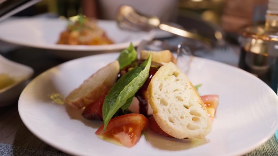 Fresh dough spins into pies at The Reef Club, where pasta shapes hold sauces without fuss. This place on the island sticks to what works: ovens run hot, pots simmer slow. Care shows in each plate, not in flashy moves but steady hands. Choices stay tight - no clutter, just flavor that lands clean.

Right off, the burrata sits under a glaze of thick balsamic, laid across leaves of sharp rocket, slices of sun-warmed tomato, torn basil, and a slow drizzle of fine olive oil. Break into the cheese, you find it soft, rich, spilling out - real deal stuff, just milky enough to let the syrupy tang shine through. Bitterness from the greens cuts clean, keeps everything steady.

Baked slowly, the tagliatelle with beef ragu features a rich red sauce made from ground meat, ripe tomatoes, and herbs, served on noodles firm to the bite, not merely claimed so. Rising from high heat, the margherita topped with beef pepperoni carries a base that chews just enough, marked by smoky edges - true to oven-fired tradition.

A meal sticks in memory when the moment fits just right. Music floats over from a corner, soft and unforced. Waves slip between notes like quiet reminders of where you are. Air moves off the water, gentle against your skin. This kind of ease never copies well indoors. Certain pairings belong only to places far from city noise.