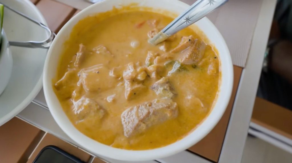 Broth bubbles on the stove, thickened by coconut milk and sparked with spice. Tuna arrives two ways - curry first, then paste beside it. Warmth rises from the pot where richness meets sharpness. Creamy liquid wraps around each flake of fish. Spices wake up the taste without drowning the mild ocean flavor.